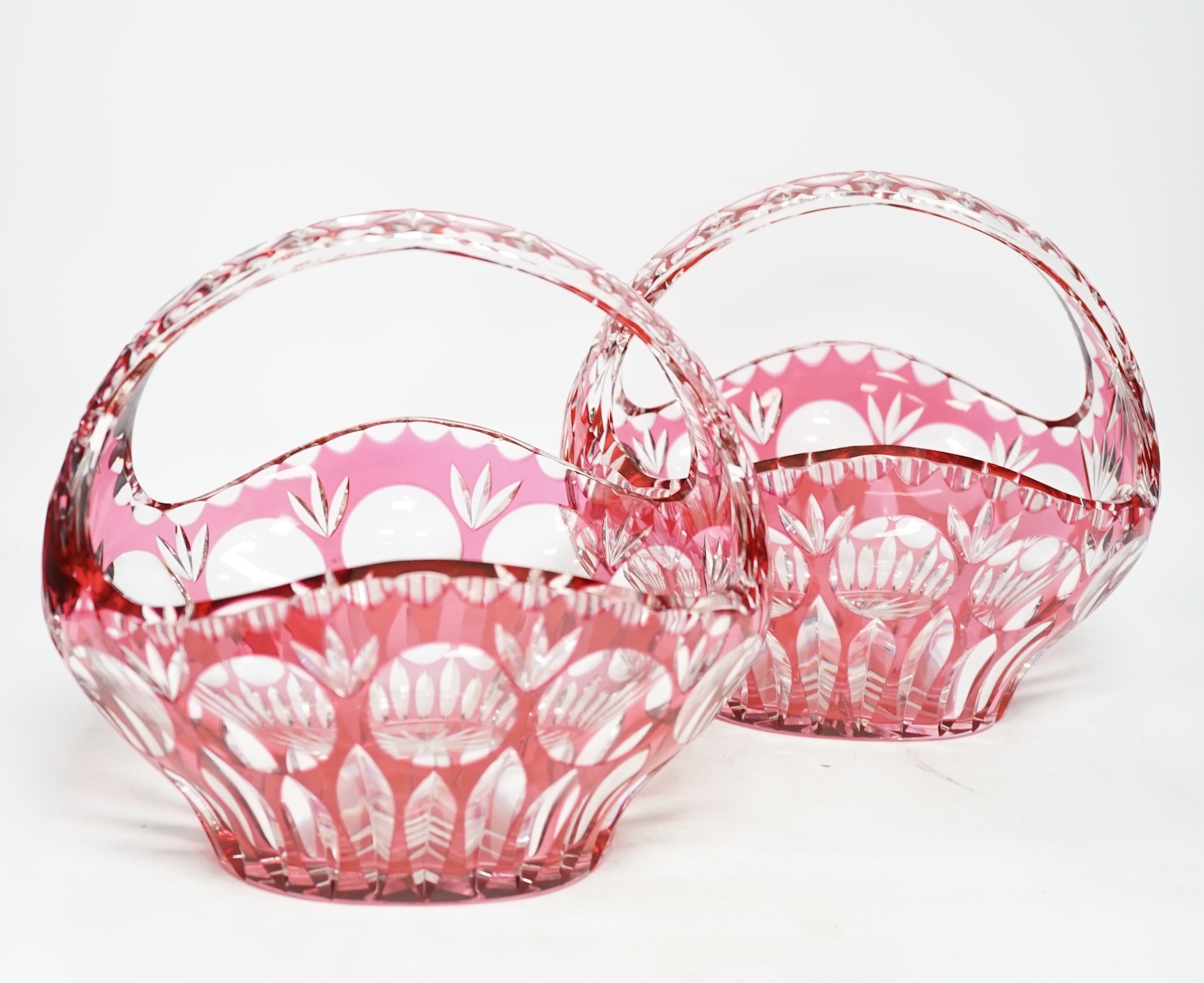 A pair of overlaid cranberry flashed baskets, 26cm wide. Condition - good